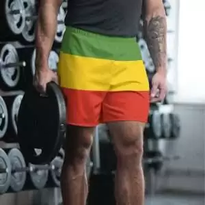 Rasta shorts front view model view at Rastaseed.com streetwear. Great for surfing, swimming and sports as they are quick dry and 96% recycled polyester.