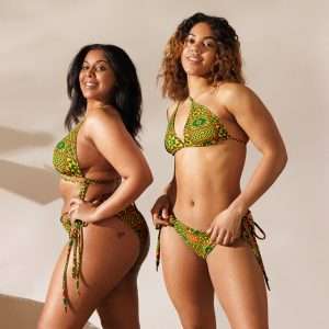 Rasta Kente string bikini two models front and side views inspired by the beautiful Kente cloth of Africa in muted Rastafarian colors. Soft and stretchy in sizes up to 6XL.