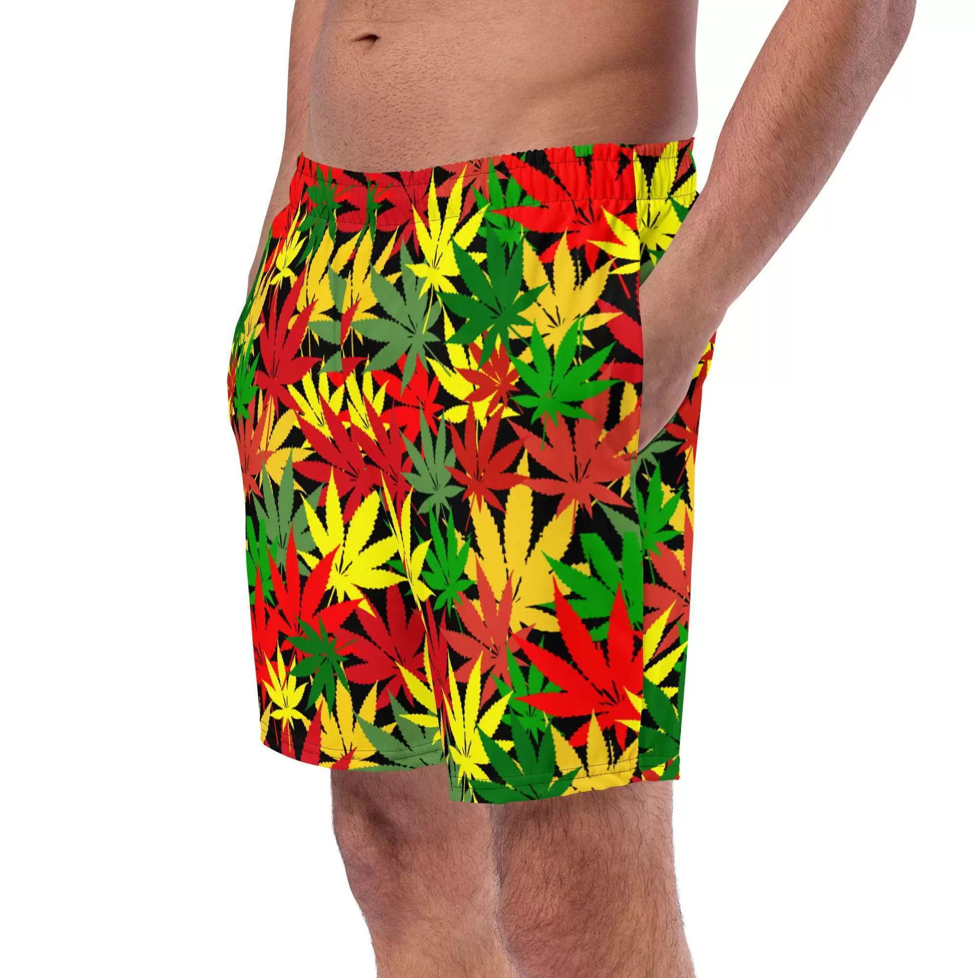 Hemp Leaf Boardshorts in Rasta colors of red gold and green with black background and stitching left side front model view. Rastafarian shop for clothing and accessories.