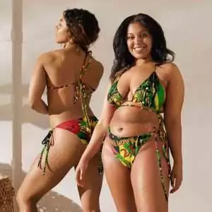 Plus Size Jamaican Bathing Suit in large selection of sizes front model view. Sexy string bikini with black lining. Fun vibrant print in bright colors.