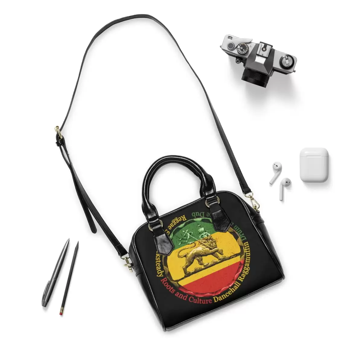Reggae purse context view with shoulder strap made from PU leather. Black with the Reggae colors and Lion of Judah Design stamp featuring Reggae genres.