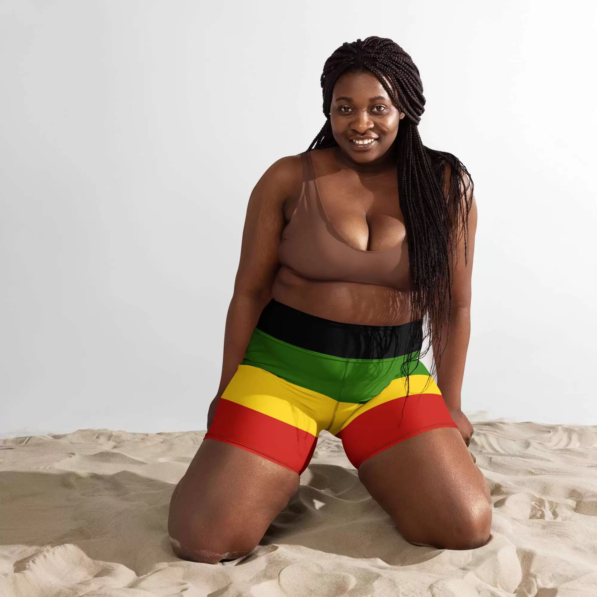 Rasta surf shorts model front view in polyester and spandex. Great for swimming, running, hiking, athletics or surfing. Rastafarian colors red gold green and black.