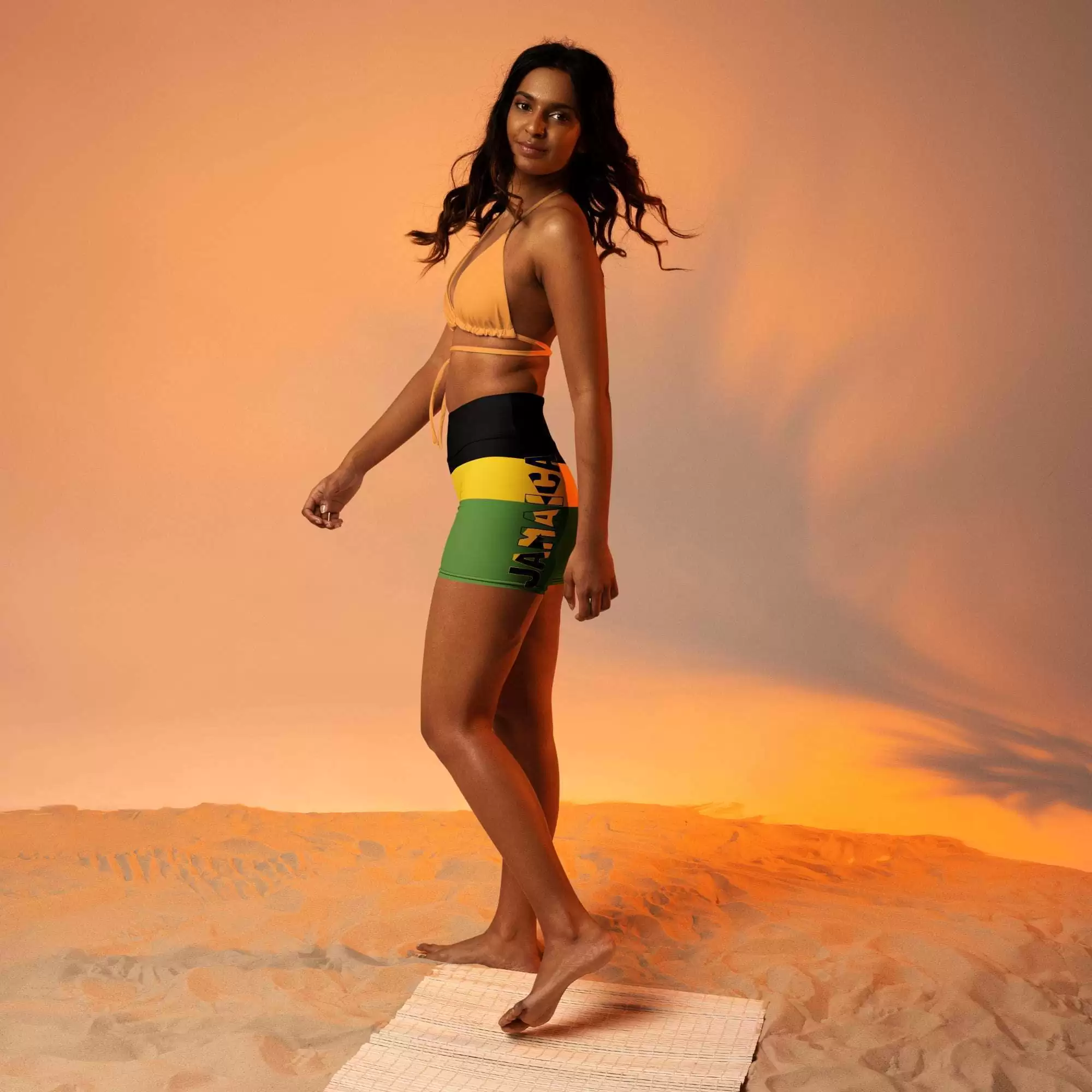 Jamaican shorts model view for walking, running, swimming, yoga and sport. Jamaican colors, tight fit with Jamaica written down the side.