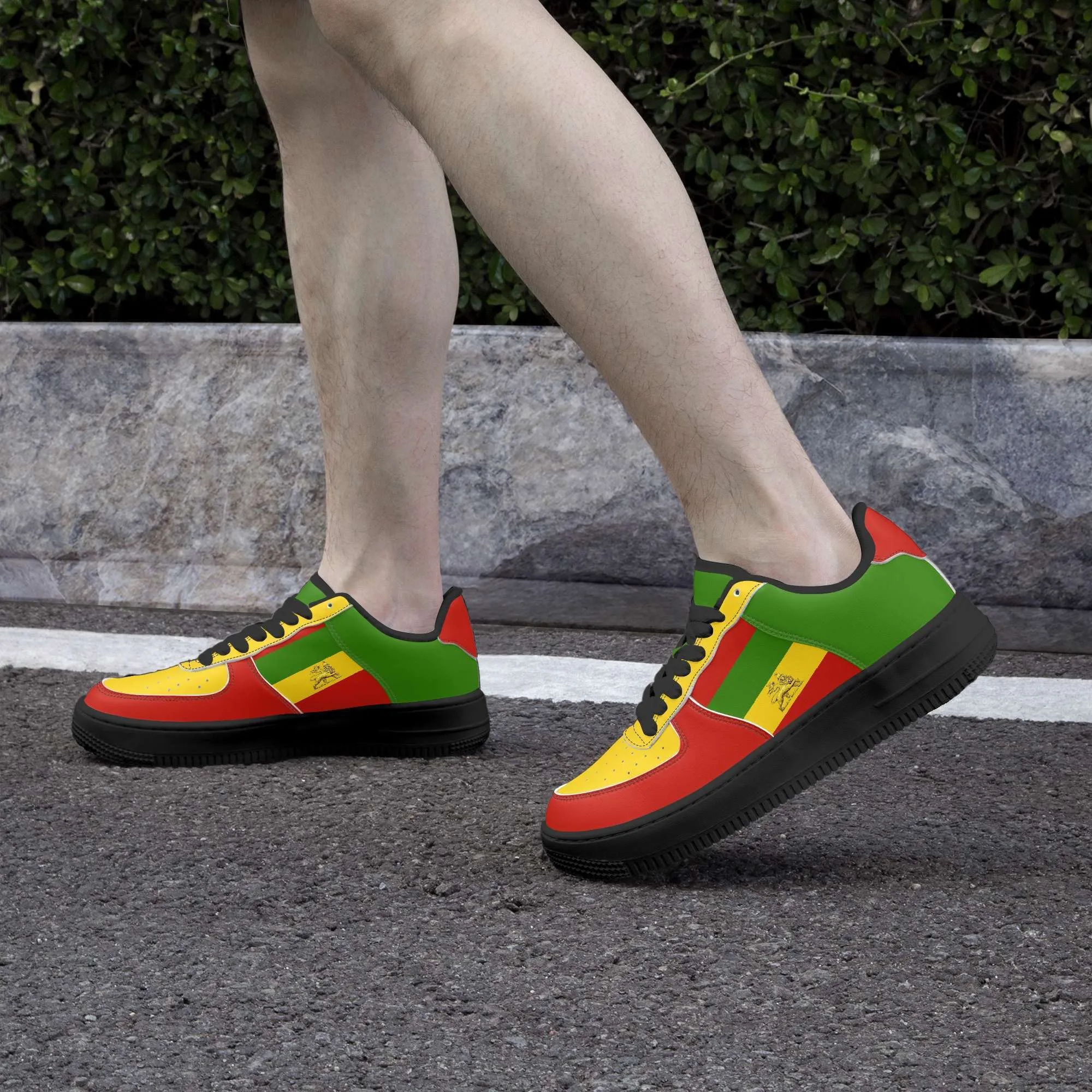 Rastafarian shoes in red gold and green. Sneakers with thick black sole pair model side view black trim. Durable and colorful. Rastaseed Brand of merchandise and clothing.