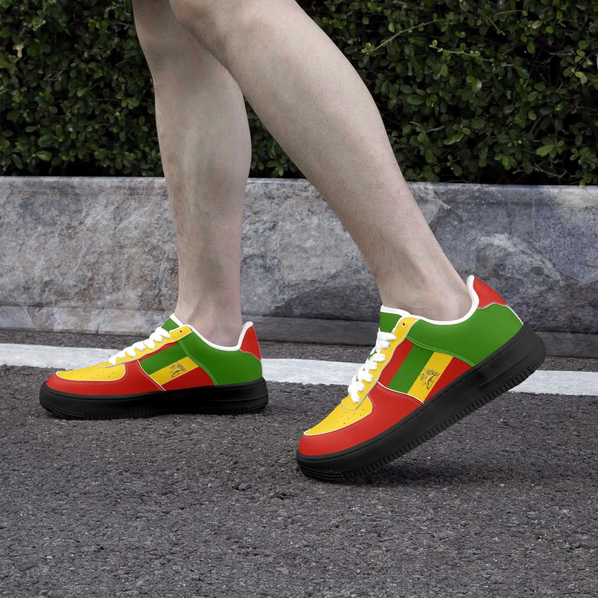 Rastafarian shoes in red gold and green. Sneakers with thick black sole pair model side view white trim. Durable and colorful. Rastaseed Brand of merchandise and clothing.