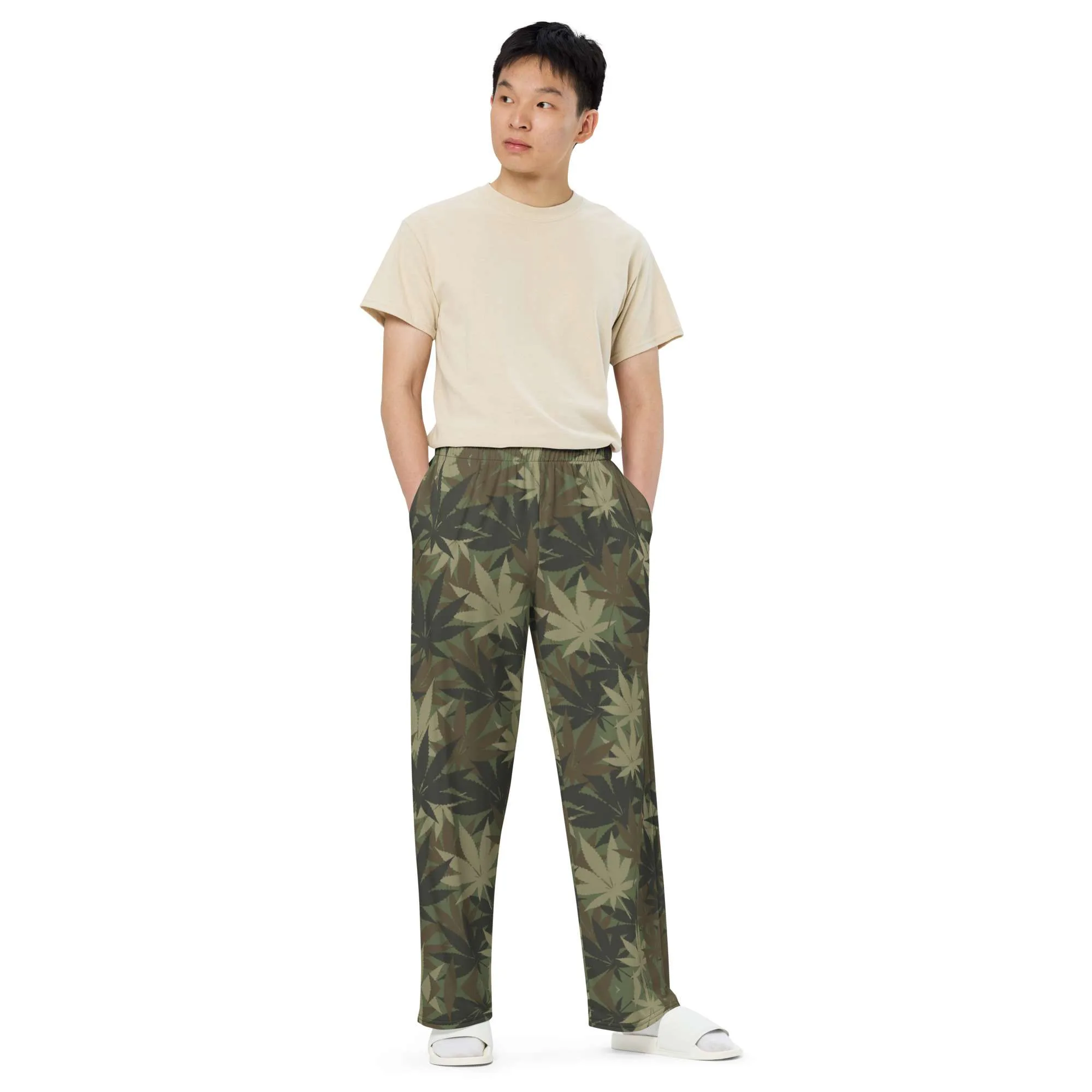 Rasta Hemp Leaf Camouflage Khaki unisex wide-leg pants side male model view. Subtle cannabis leaf design. Rastaseed brand of culturally inspired clothing.