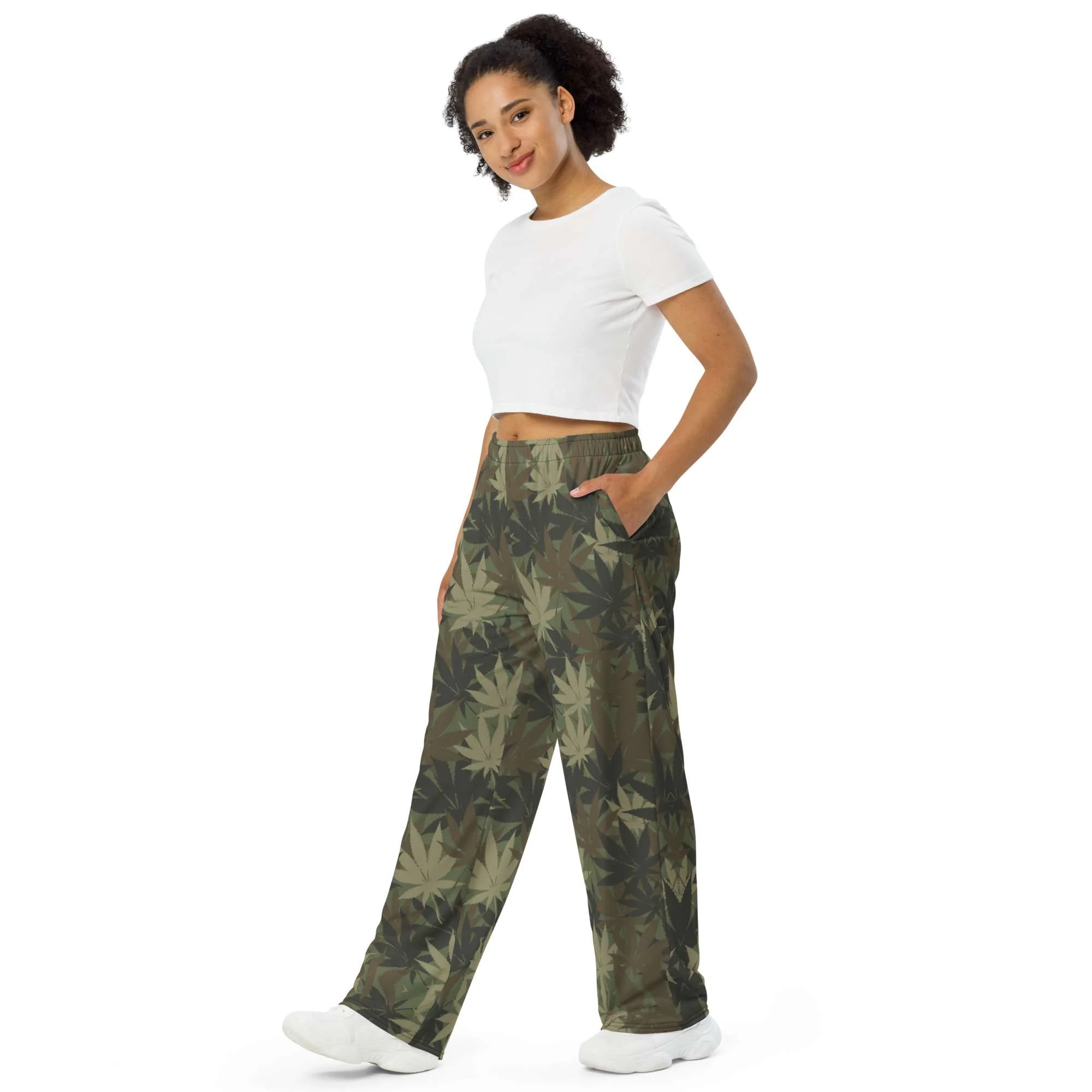 Rasta Hemp Leaf Camouflage Khaki unisex wide-leg pants side female model view. Subtle cannabis leaf design. Rastaseed brand of culturally inspired clothing.