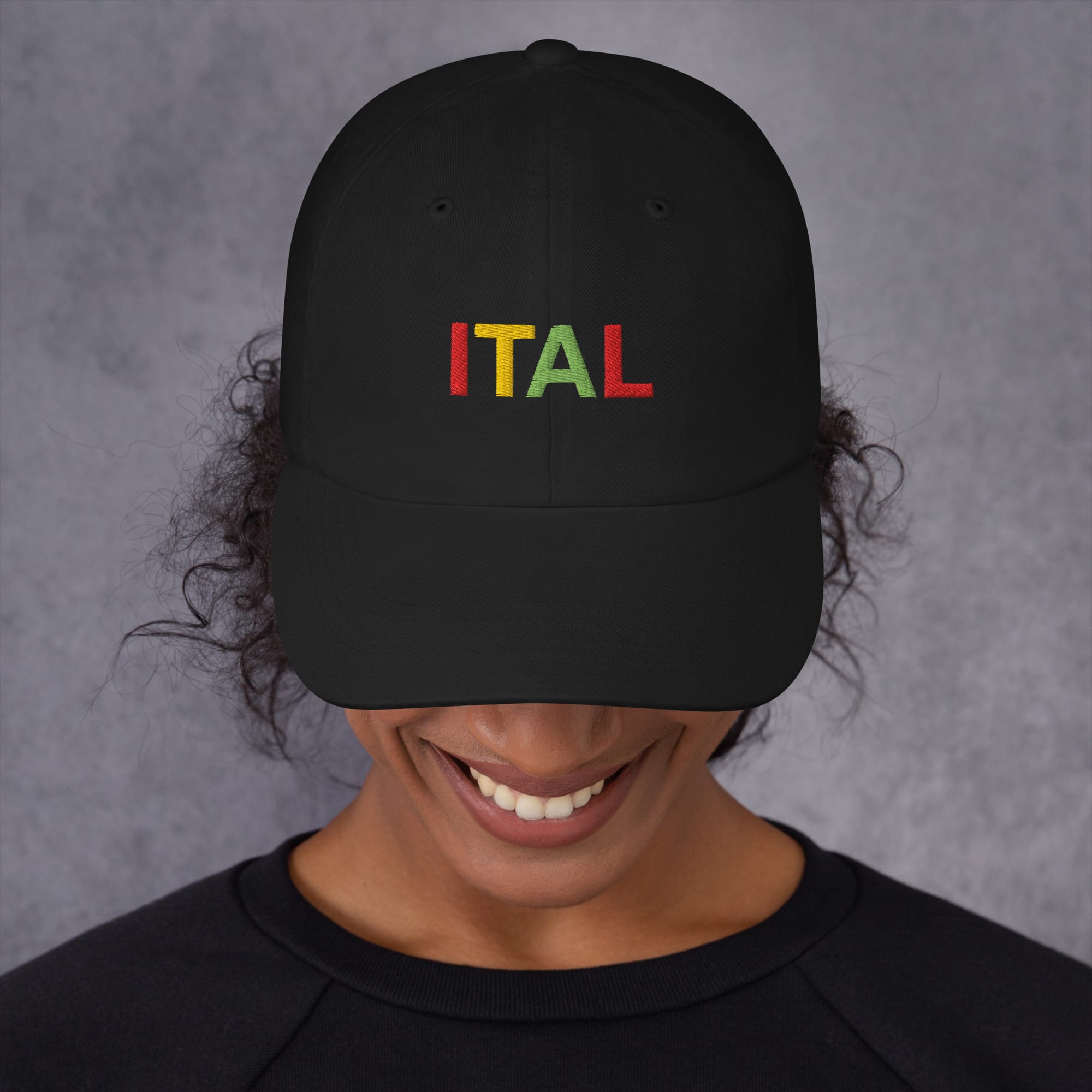 Ital Jamaican Patois Cap female view available in khaki camouflage and black with red gold green embroidered letters. Original designs at Rastaseed clothing store. front black
