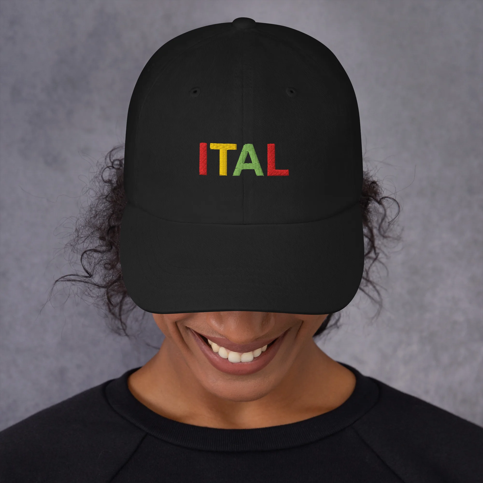 Ital Jamaican Patois Cap female view available in khaki camouflage and black with red gold green embroidered letters. Original designs at Rastaseed clothing store. front black