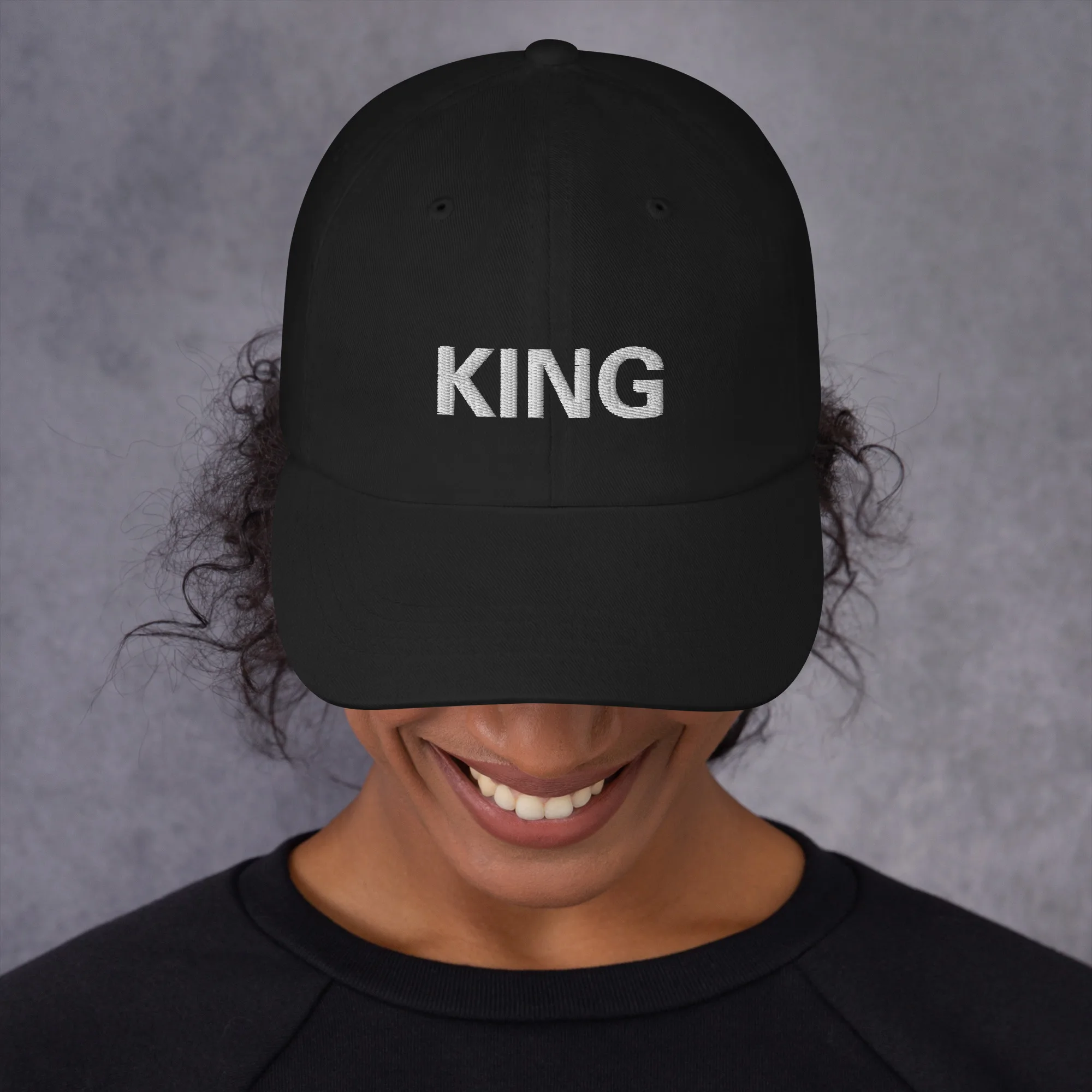 King Rasta Cap in khaki or black. Original Jamaican designs at Rastaseed.com. Reggae gear and original Rastafarian clothing store. Front black model view.