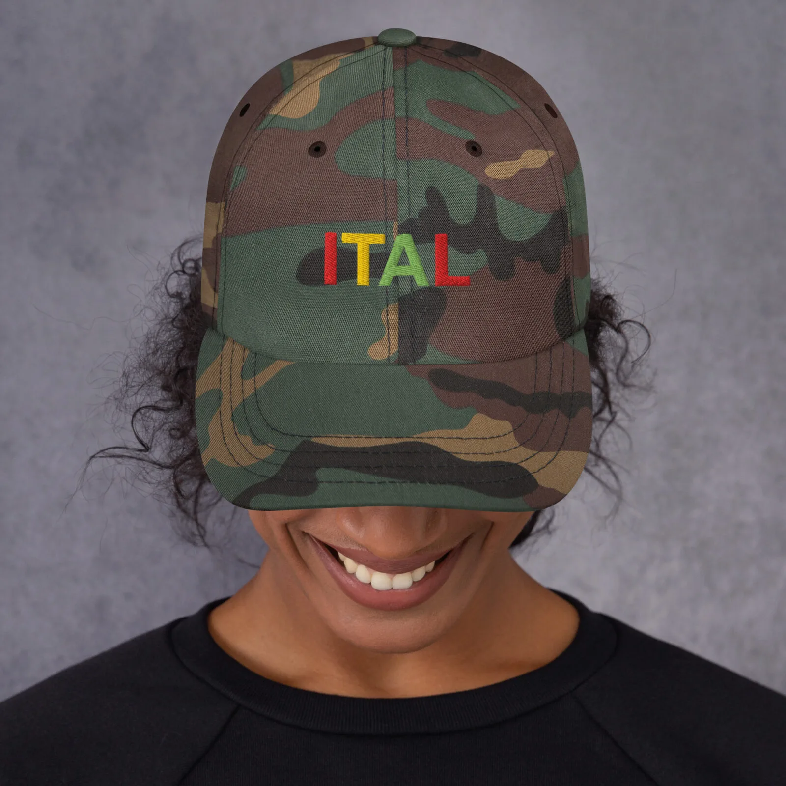 Ital Jamaican Patois Cap female view available in khaki camouflage and black with red gold green embroidered letters. Original designs at Rastaseed clothing store. front camoulage print