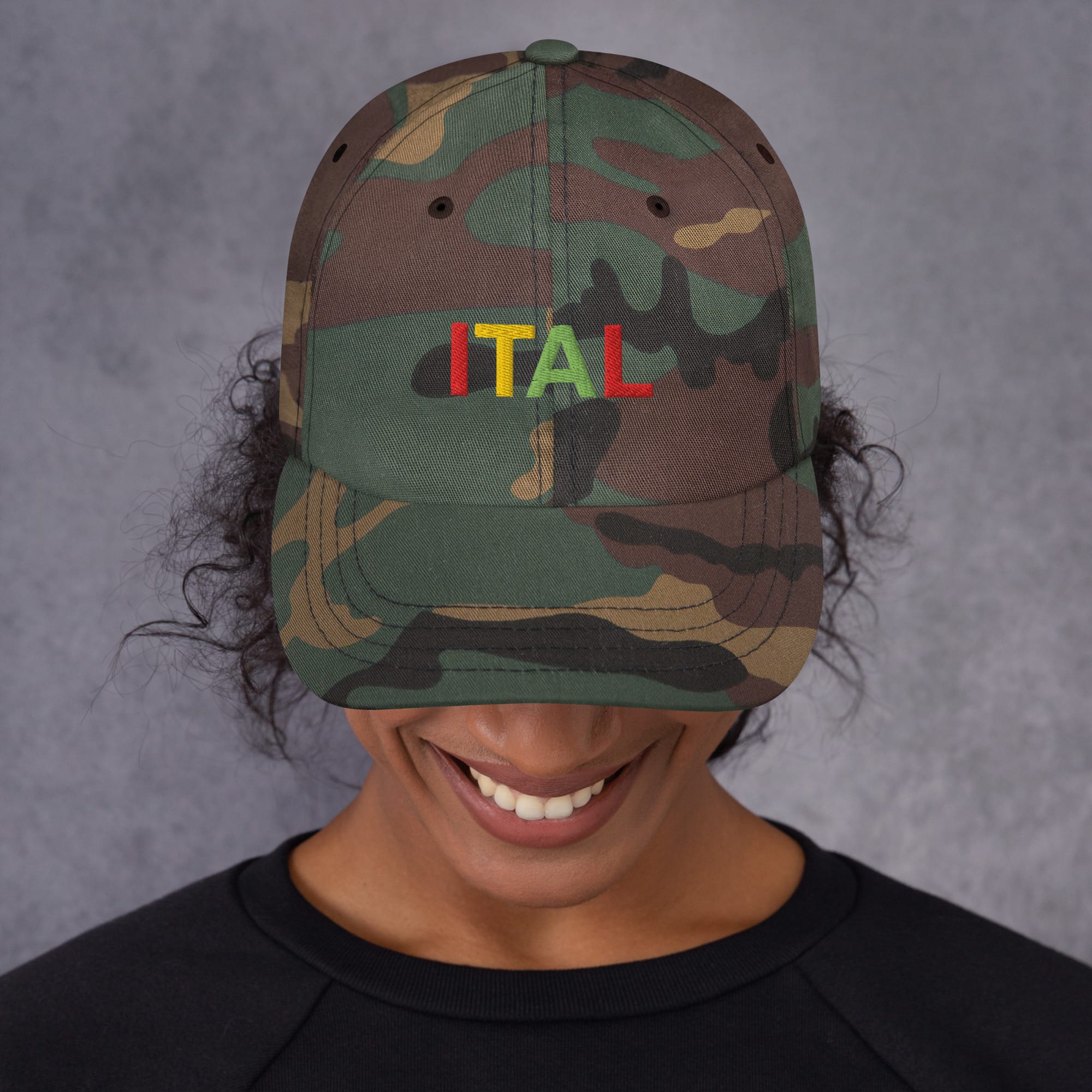 Ital Jamaican Patois Cap female view available in khaki camouflage and black with red gold green embroidered letters. Original designs at Rastaseed clothing store. front camoulage print