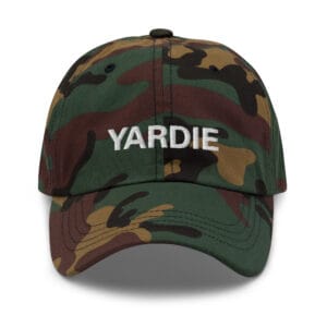 Yardie Jamaican Patois Cap front view in dad hat style. Available in Khaki camouflage and black. Rastaseed original Rastafarian merchandise and clothing shop. Front camo cap