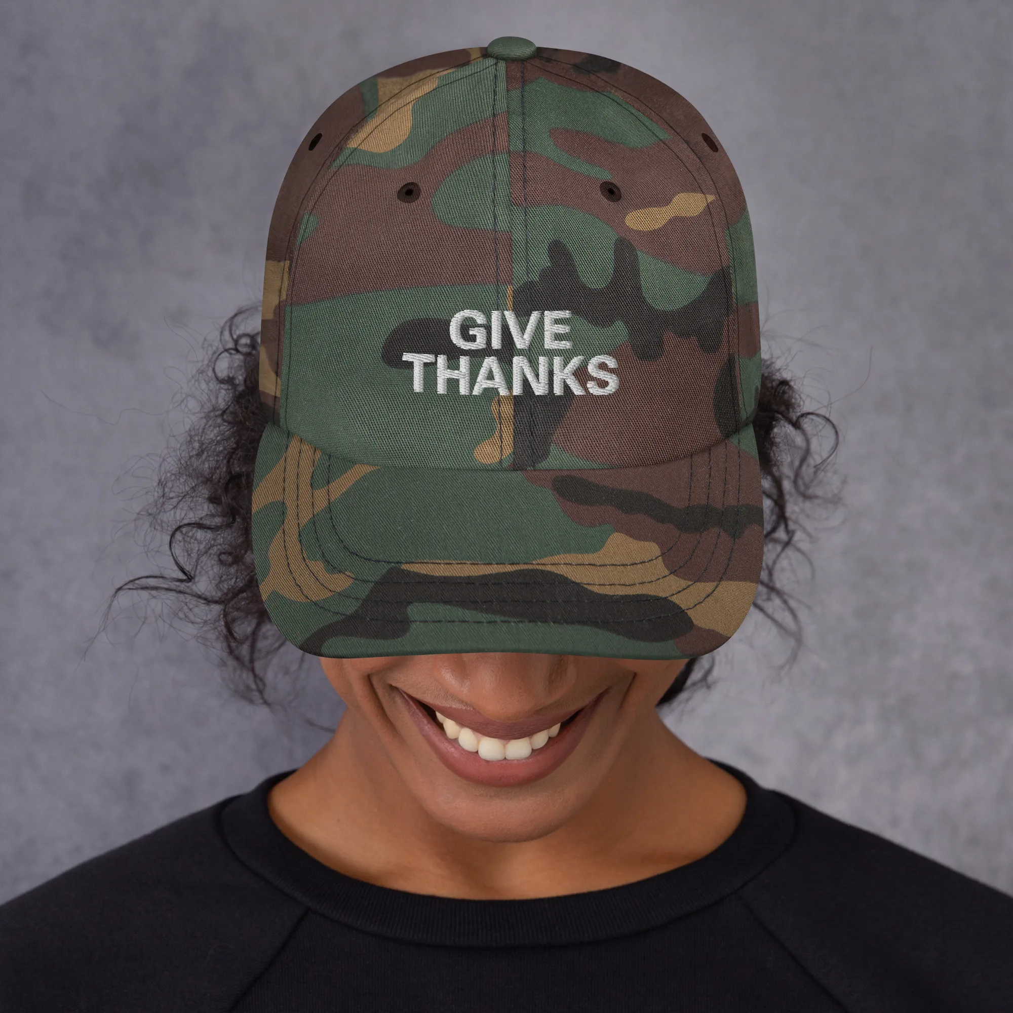 Give Thanks Rasta Cap front view camo available in khaki camoflage print and black colors. White embroidered lettering and dad hat style. Rastaseed original design. Front camo model view.